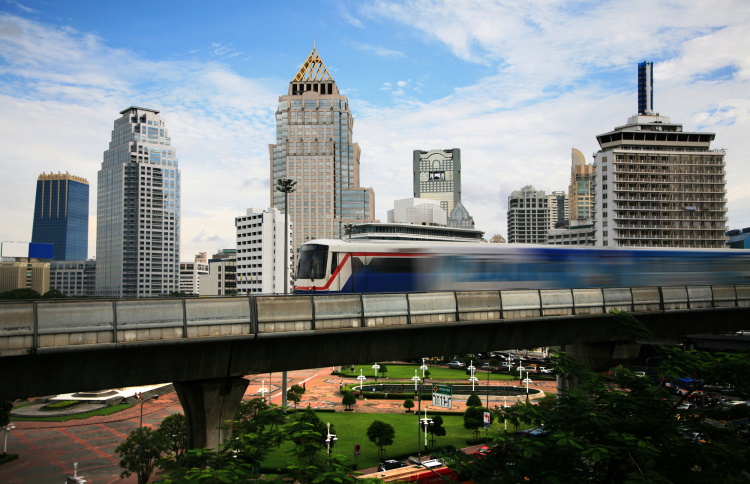 Bangkok Skytrain With Large Buildings In The Background