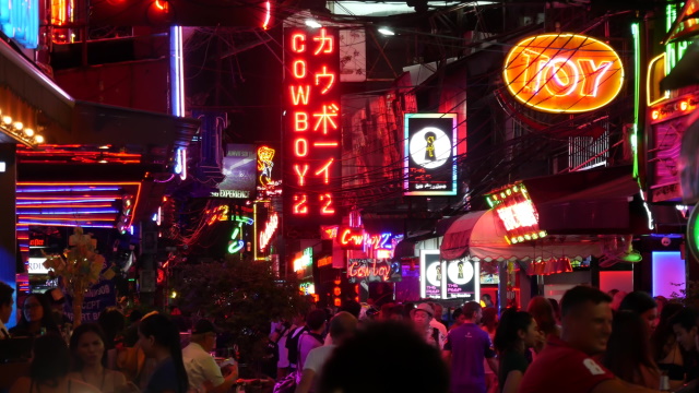 Vivid Neon Signs Glowing On Soi Cowboy Street. Nightlife In Erotic Red Light District. Illuminated Bar And Adult Go-Go Show Club. Night Life Tourist Entertainment.