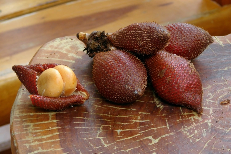 Snake Fruit In Its Skin And Out On A Wooden Thai Table