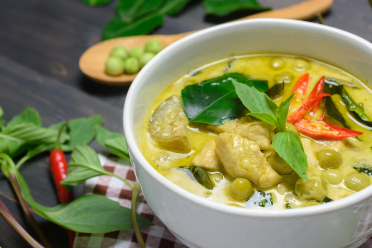 Thai Green Chicken Curry In White Bowl On A Wooden Table