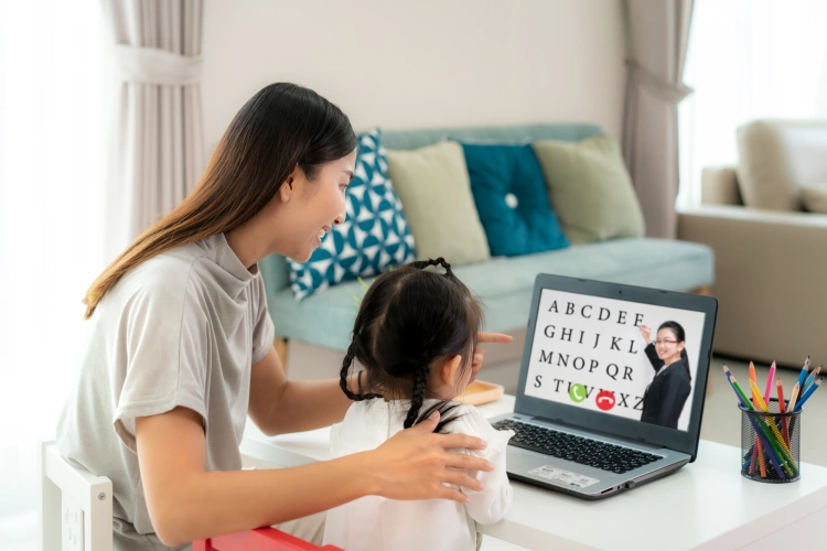 Thai Mother With Daughter Learning The English Alphabet Online On Laptop