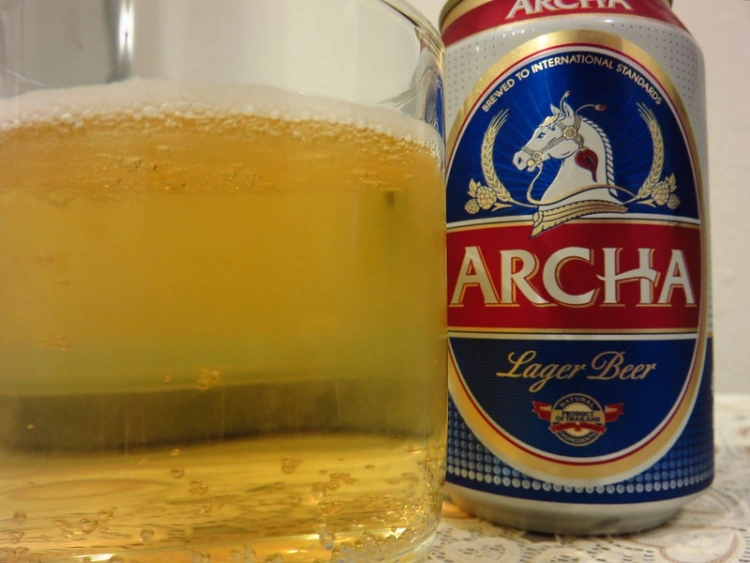 Can Of Thai Archa Beer And Glass With Beer Inside