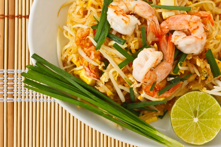 Close Up Of Stir Fry Pad Thai Noodles On Bamboo Table Mat