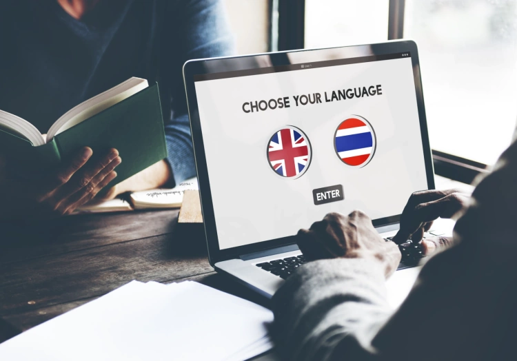 Man Choosing Between The Language Thai Or English On A Laptop Screen