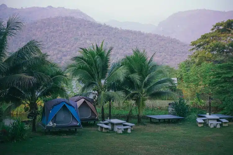 Ploenkarn Camping By The River Campsite In Kanchanaburi With River And Hill Background