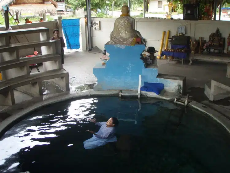 Floating Nun At Kanchanaburi Temple With Person Taking A Photo
