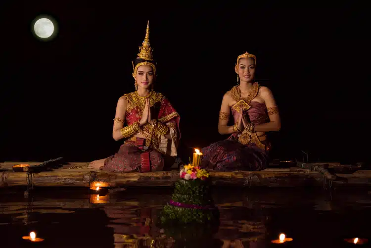 Beautiful Thai Women In Traditional Thai Dress Sitting Near Water At Loy Kratong