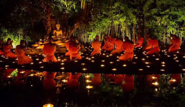 Buddhist Monks On Makha Bucha Day Praying At Night To A Buddhist Statue