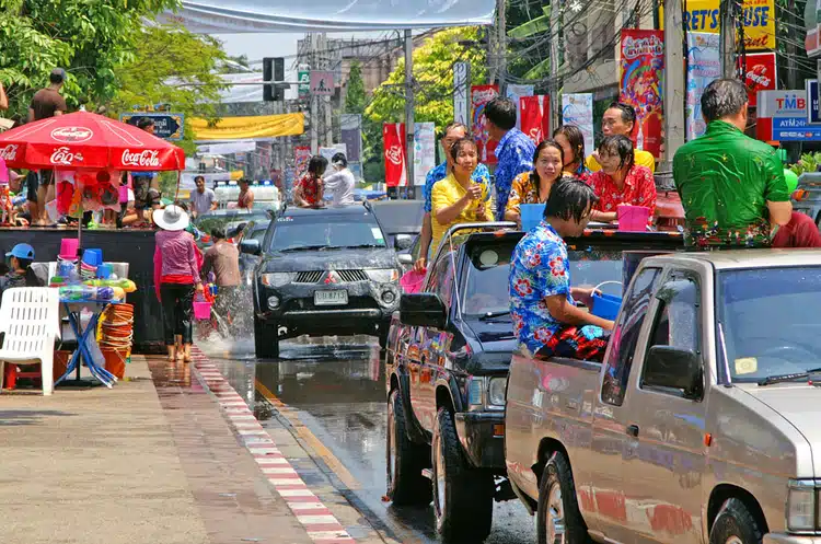 Trucks With Thai People Throwing Water At Songkran Festival In Thailand On A Hot Day